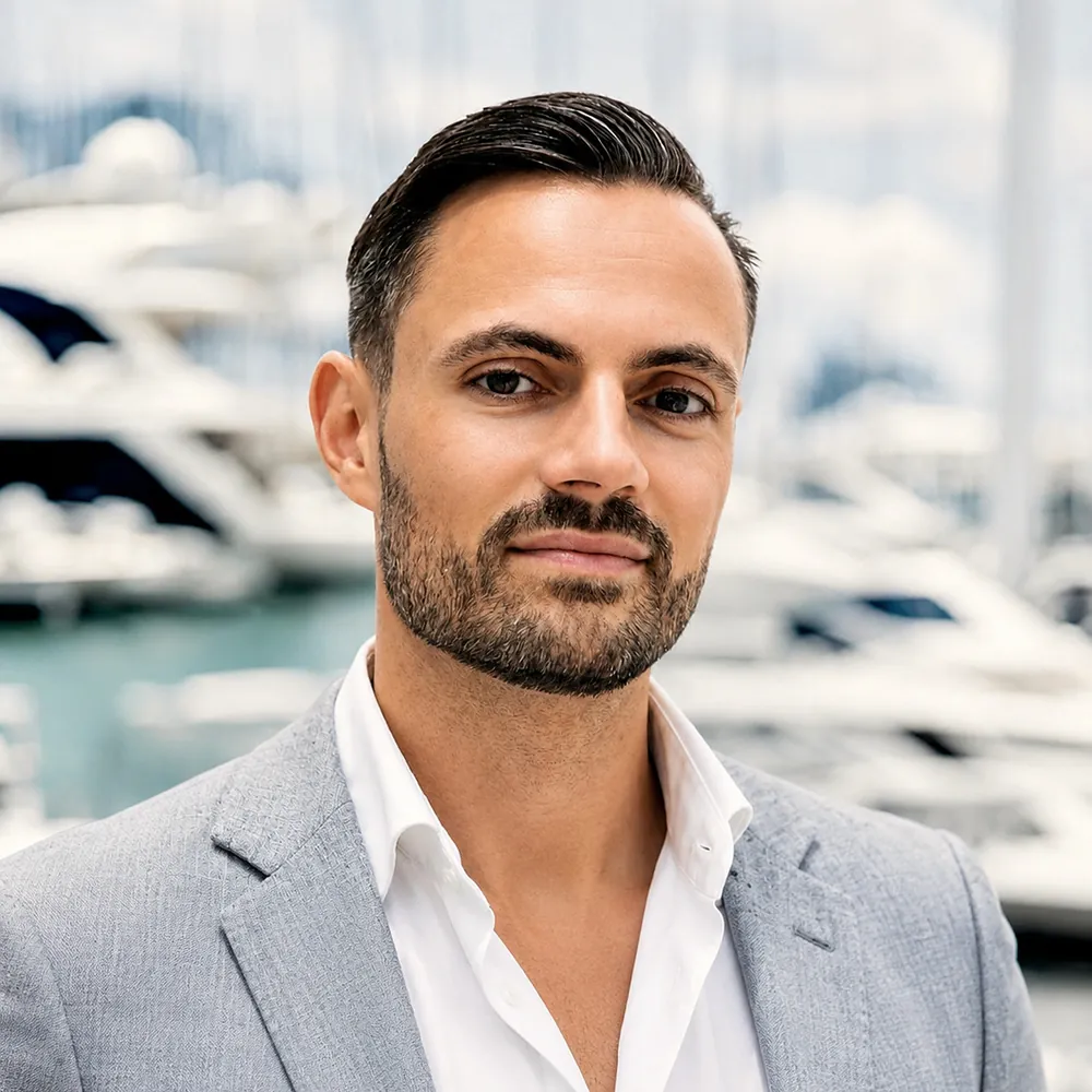 Tim Daum, co-founder, in a light grey jacket at a marina